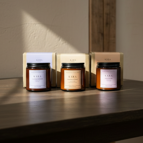 Three candles with 'KARA' branding on a wooden surface.
