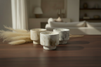 Three stone candles on a wooden surface with a blurred indoor background