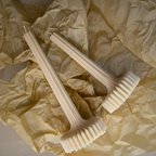 Two pillar candles on crumpled beige paper