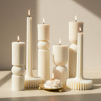 Set of decorative candles with unique holders on a light surface.