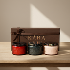 Three scented candles gift box on a wooden surface.
